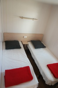 photo de d'une chambre avec deux lit simple de mobil home au camping le bois de pins a salses photo prise part digital duo 66